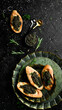 Sandwiches with black caviar, caviar in a bowl. On a black stone background. Rustic style.