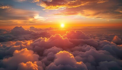 Wall Mural - Beautiful sunset above the clouds. Aerial view. Nature background of sky. Cloudy landscape from the window of an airplane. Sunrise. Sun goes into the clouds. Illustration for varied design.