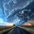 Dramatic supercell storm with massive swirling clouds over a rural road at sunset