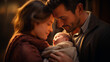 Young family tenderly looking at their newborn baby, illuminated by a warm golden light