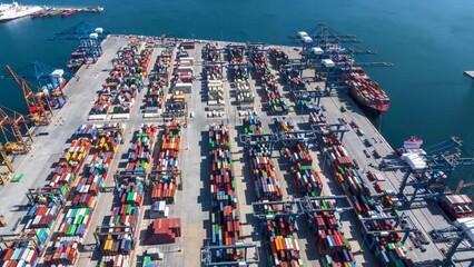 Wall Mural - Aerial hyper lapse view of a industrial cargo container terminal with loading and unloading activity