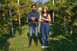  man and a woman stand in a field of oranges