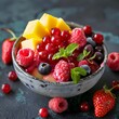 A mixture of raspberries, strawberries, blueberries, grapes and nectarines creates a nutritious dessert with fruit salad, space for text
