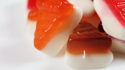 Wall Mural - Gummy candies form of cheesecake on white background.