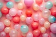 A high-angle view of a solid pastel-colored background filled with balloons of various sizes floating playfully