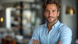 © IC Production - Happy young smiling confident professional business man wearing blue shirt, pretty stylish male executive looking at camera, standing arms crossed at grey background concept.