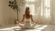© Ekaterina Chemakina - A woman does yoga or meditates at home. A young woman is sitting on the floor with her back to the camera in a bright room.