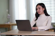 © Kainnika - Young beautiful Asian woman working at home.