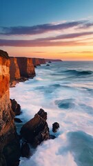 Wall Mural - Sunset Beach Horizon: A serene coastal landscape with vibrant hues of sunset reflecting on the tranquil sea, framed by rocky shores and soft clouds