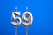 Birthday number 59 - Candle lit on blue background