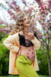 happy young girl pregnant near cherry blossoms, belly with flower ornament, spring vibe, new life