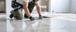 © Valentin - Tiler lays floor tiles