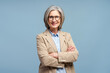 © Maria Vitkovska - Smiling senior business woman wearing eyeglasses looking at camera, posing arms crossed isolated