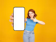 © Designerant - Close up phone mock up, young fun charming caucasian red bob hair woman hold use point finger on close up phone mock up with empty white blank touch screen isolated on yellow background  copy space.