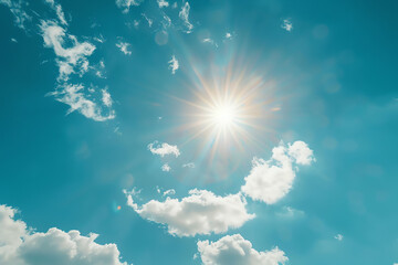 bright sunlight shining through fluffy white clouds on a clear blue sky in the afternoon