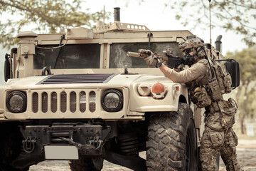 United States Army in camouflage uniforms operation in the forest.with armored vehicle, soldiers training  in a military operation