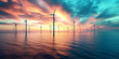 Alternative and clean energy: farm of wind turbines offshore against a beautiful sunset on the sea