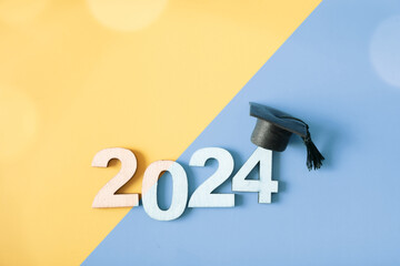 Wall Mural - Wooden number 2024 with graduated cap. Class of 2024 concept