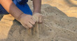 Playing with sand in the playground with hands small hand muscles large muscles of young children at an age when their bodies are growing and becoming strong according to childhood
