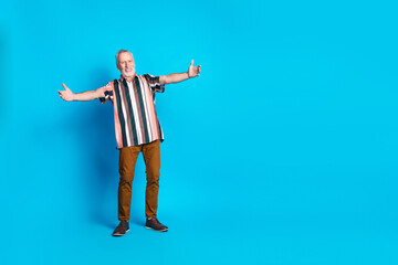 Poster - Full length photo of glad positive senior man wear striped trendy clothes empty space isolated on blue color background