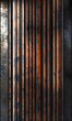 A vertical image showcasing a series of old, rusty metal pipes with contrasting areas of light and shadow.
