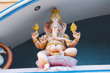 Wall Mural - Sculpture of god Ganesha on the roof of a Hindu temple in India.