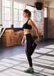 © peopleimages.com - Woman, gym and stretch leg for warmup for workout with preparation for exercise or training for health. Wellness, sports and muscle with aerobics for stamina or strength with fitness in morning.