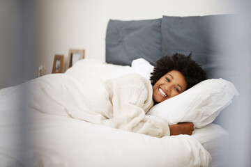 African, woman relax and bed in home, blanket and comfort on weekend morning for rest and wellness. Happy, smile and awake feeling positive or calm and peace, lazy Sunday and bedroom in apartment