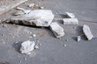 Broken concrete slab on asphalt