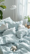 : A serene sky blue linen bedspread with fluffy clouds pillows in a child's bedroom