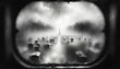 © Khritthithat - Gloomy view of an eerie, fog-covered cemetery seen through the misty window of a dark room.