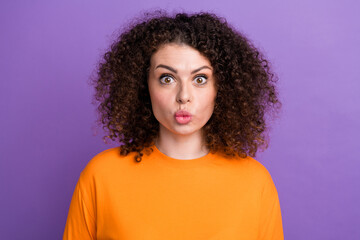 Wall Mural - Photo of funky excited lady dressed orange t-shirt big eyes sending you kiss isolated violet color background