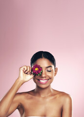 Poster - Woman, flower and wellness in studio for self care with makeup on pink background for aesthetic or organic. Springtime, plant and eye with beauty, floral and blossom with clear skin with glow.