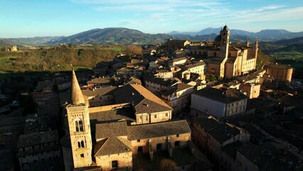 Poster - One of the most beautiful medieval towns of Italy - Urbino in Marche region. aerial drone panoramic high angle view over sunset. 4k hd video 