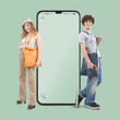 Smiling and happy young woman and young man, in front of empty screen of smartphone, looking into the camera, youth clothing and accessories shopping online and e-commerce concept