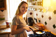 © peopleimages.com - Portrait, egg or happy woman in kitchen cooking for food, wellness or nutrition for healthy dish. Smile, breakfast or girl in home for lunch meal prep, vegan diet or protein in France on stove or pan