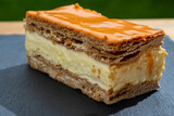 Fototapeta Kuchnia - Celebration of the King birthday in Netherlands, tompoes or tompouce, iconic pastry in Netherlands made from puff dough, orange icing, cream