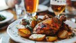 © afridwi1999 - Close-up of a plate of chicken and potatoes with a glass of beer