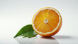 A fresh orange fruit cut in half, revealing juicy segments, with a vibrant green leaf resting on one side