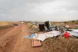 Fototapeta Do pokoju - Garbage in meadow. rubbish, trash left outdoor. Dirty environment garbage pollution