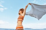 Fototapeta  - Summer Bliss: Smiling Woman Embracing Freedom and Happiness on Beach Vacation