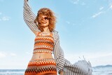Fototapeta Sport - Carefree Summer Bliss: Smiling Woman on Beach, Enjoying Nature and Sea, Embracing Happiness and Freedom.