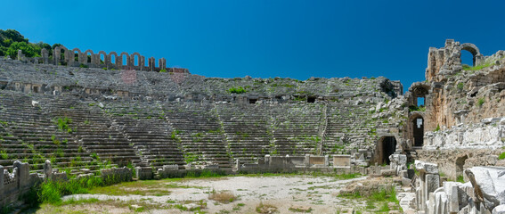 Wall Mural - Picturesque ruins of an amphitheater in the ancient city of Perge, Turkey. Perge open-air museum.