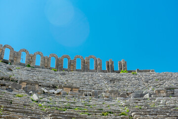 Wall Mural - Picturesque ruins of an amphitheater in the ancient city of Perge, Turkey. Perge open-air museum.