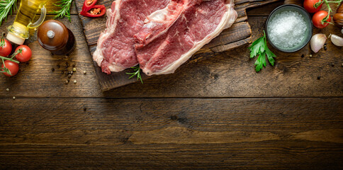 Poster - Two raw beef steak on wooden board on wood table with copy space top view