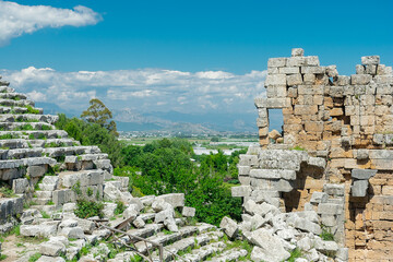 Wall Mural - Picturesque ruins of an amphitheater in the ancient city of Perge, Turkey. Perge open-air museum.