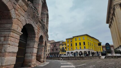 Wall Mural - Verona, Italy. Architecture of the city of Verona. Walk through the historical part of Verona Italy. City center of Verona in spring cloudy day with many people walking around