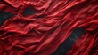 © Athena - Luxurious red fabric flowing with dramatic folds and a textured dark background, perfect for elegant backdrops and designs