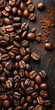 Coffee beans and ground coffee on dark background, top view