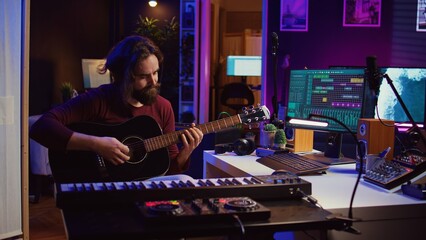 Poster - Music producer tuning his acoustic guitar before playing instrument, recording and mixing tunes to create new soundtracks. Singer composing a song using electronic panel controls. Camera B.
